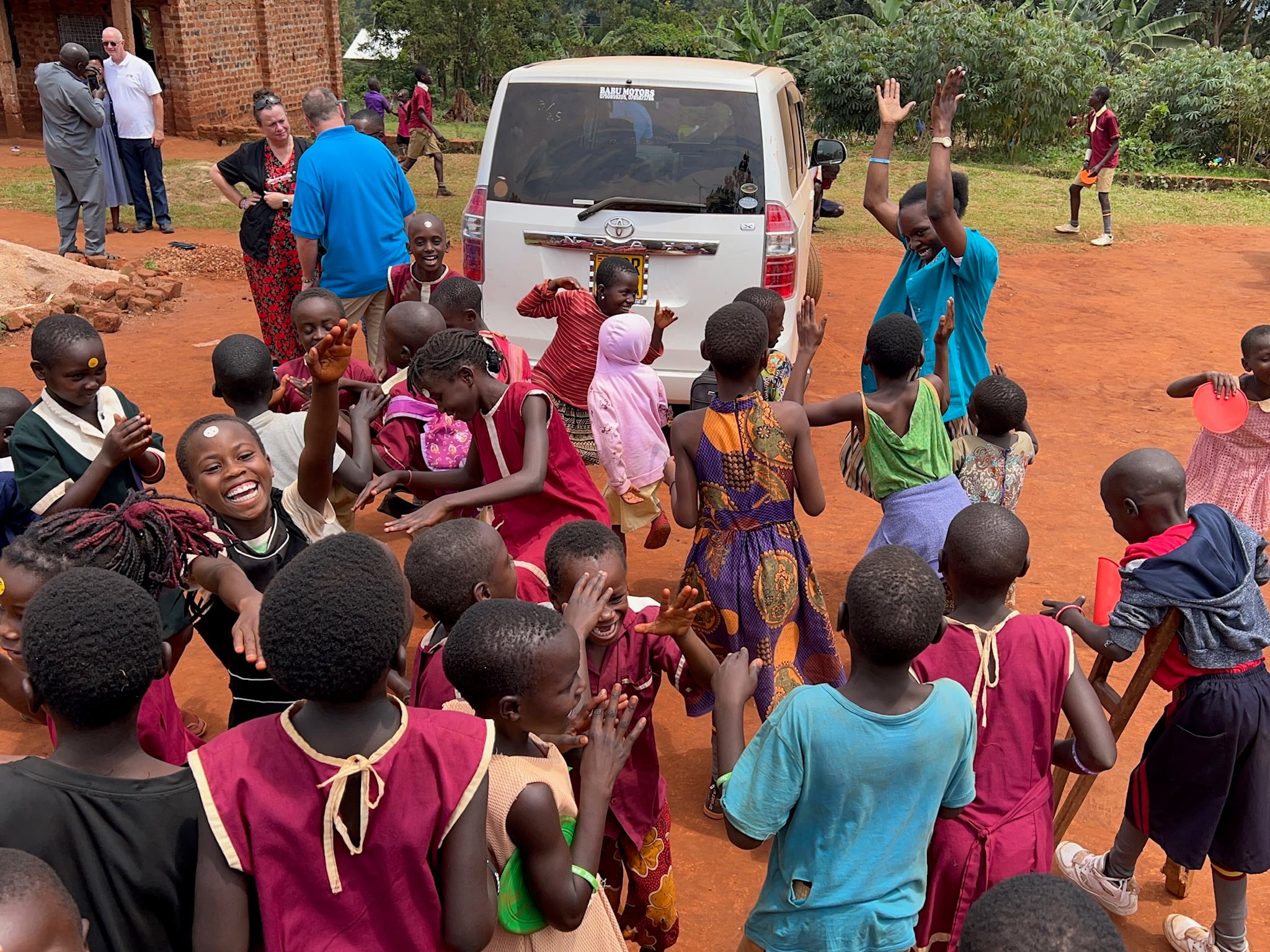 Seya Light children cheering the van, 2024.