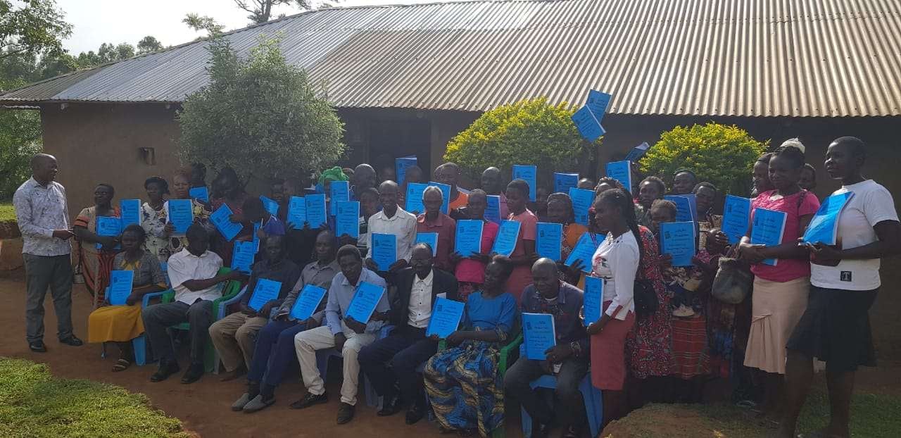 Blue workbooks at a partner symposium, 2025.