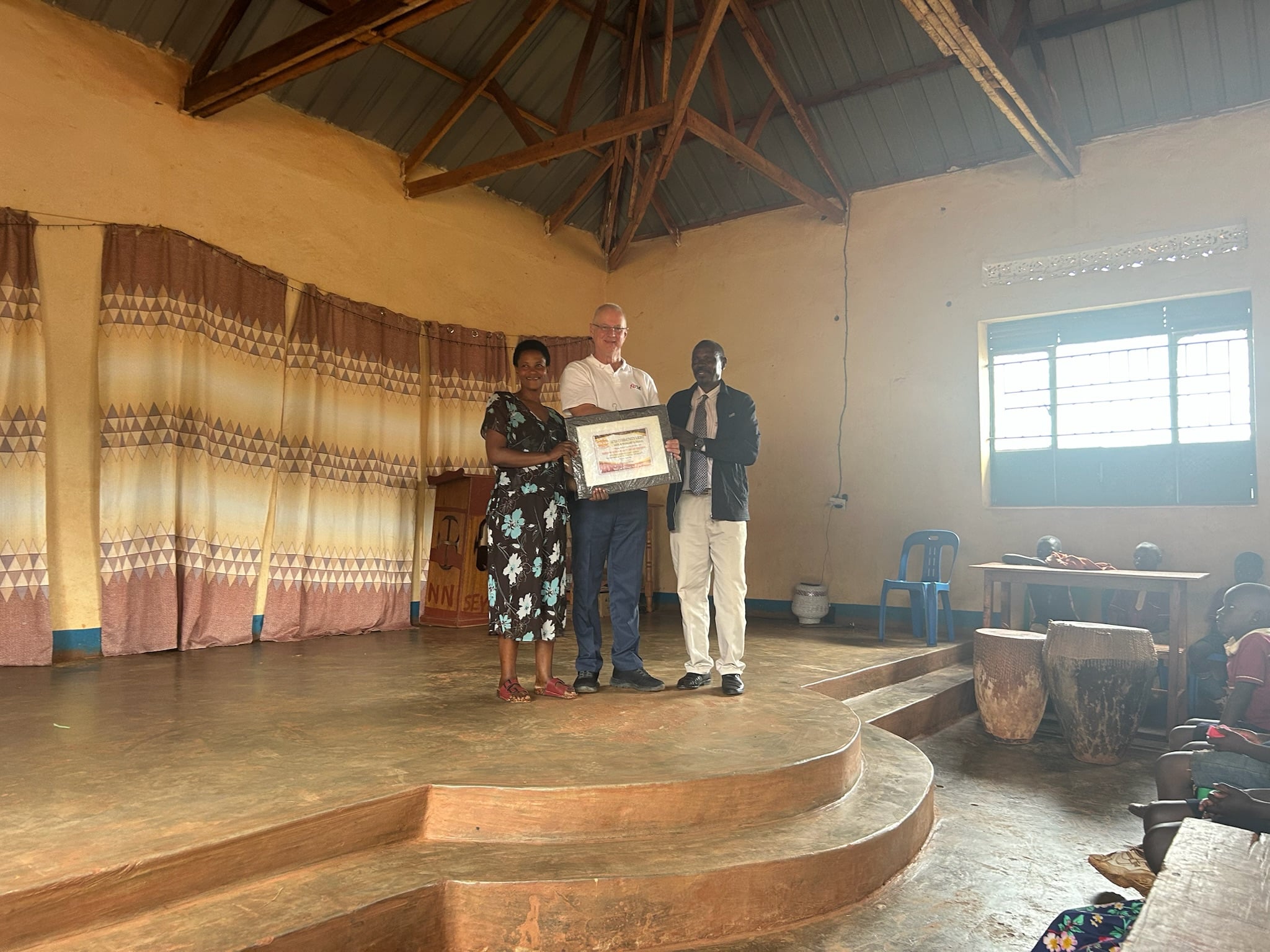 Annet and Mark with a plaque, 2025.
