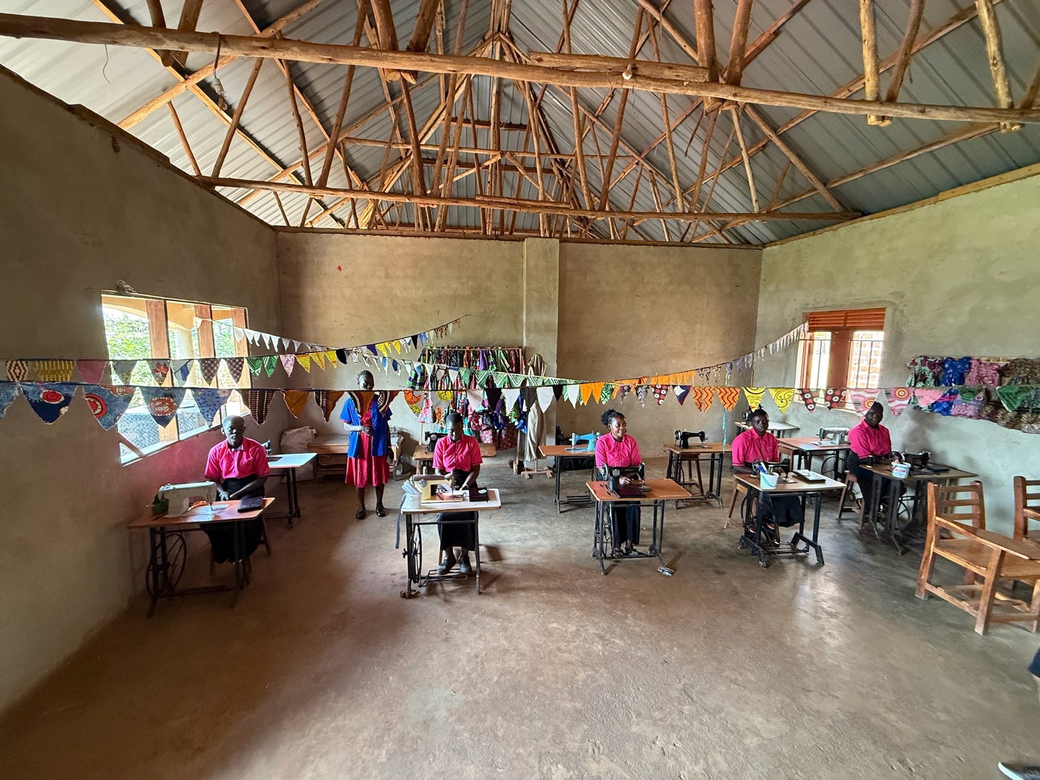 Sewing class in pink uniforms, 2025.