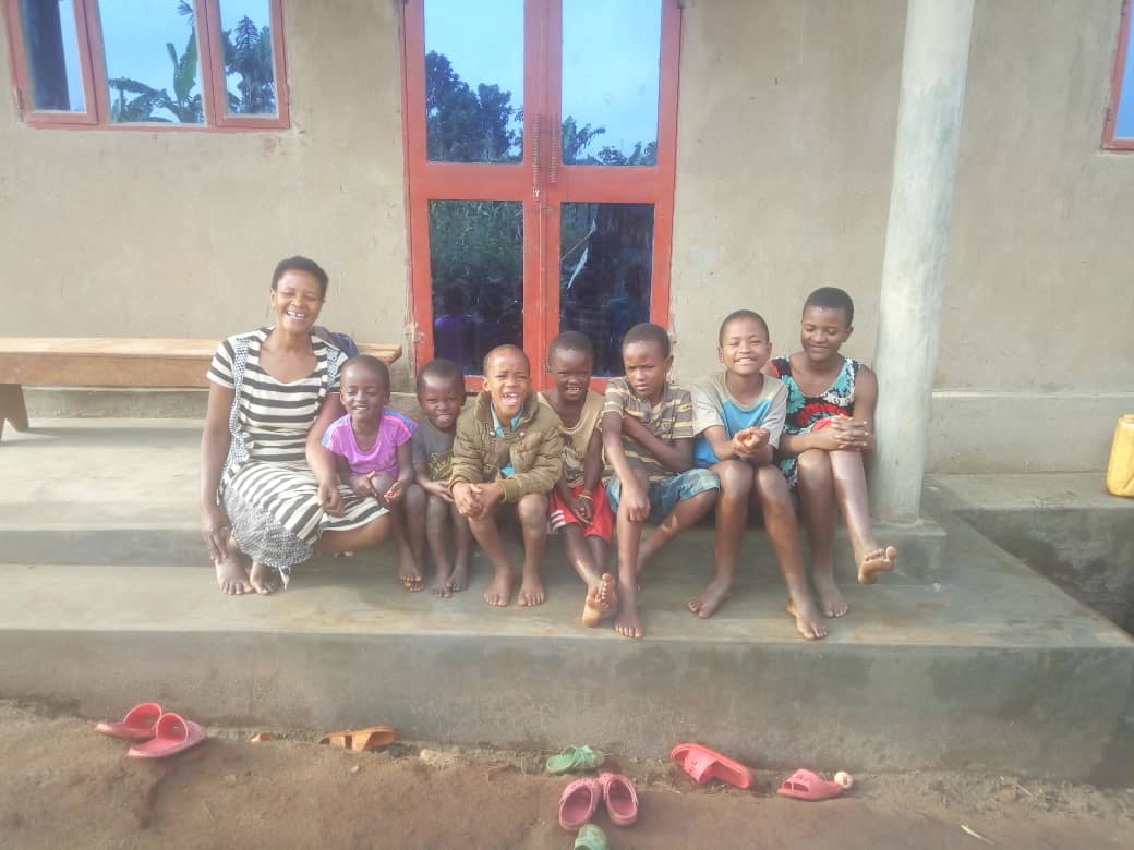 Ndifuna family house completion with family standing outside.