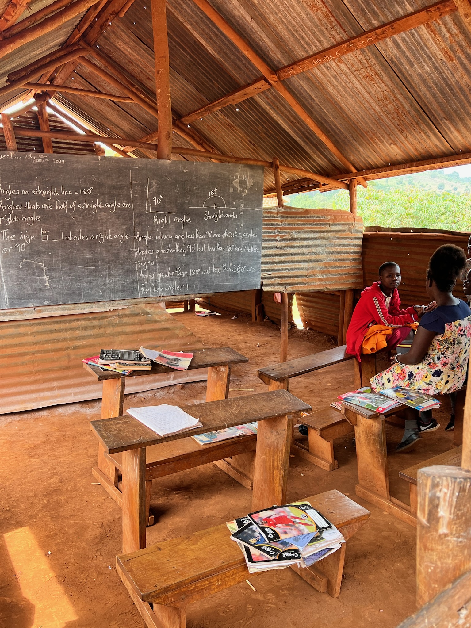 Seya Light classroom with chalkboard and students, August 2024.