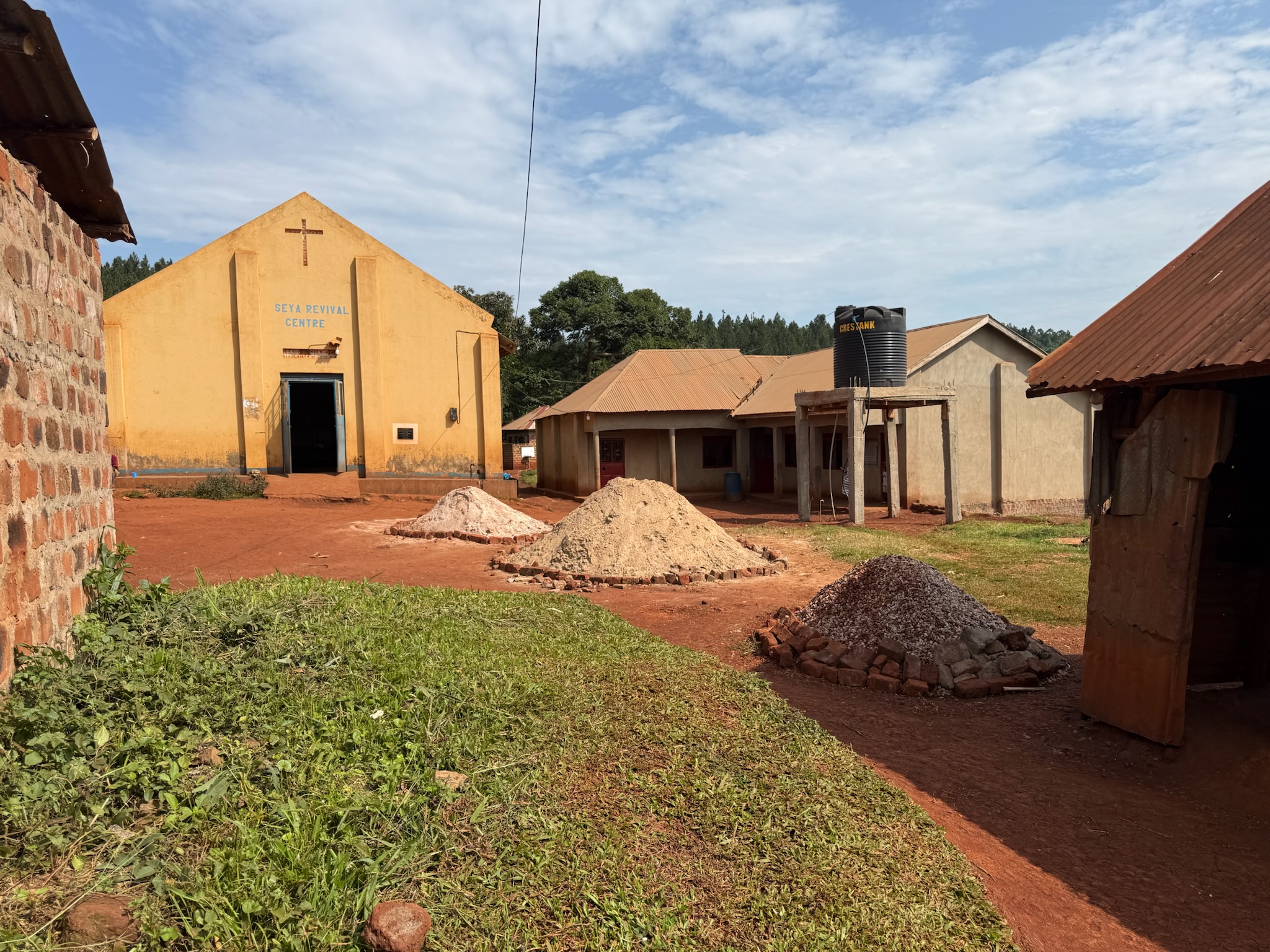 Sand and material piles at the Seya compound — prep for the new classrooms.