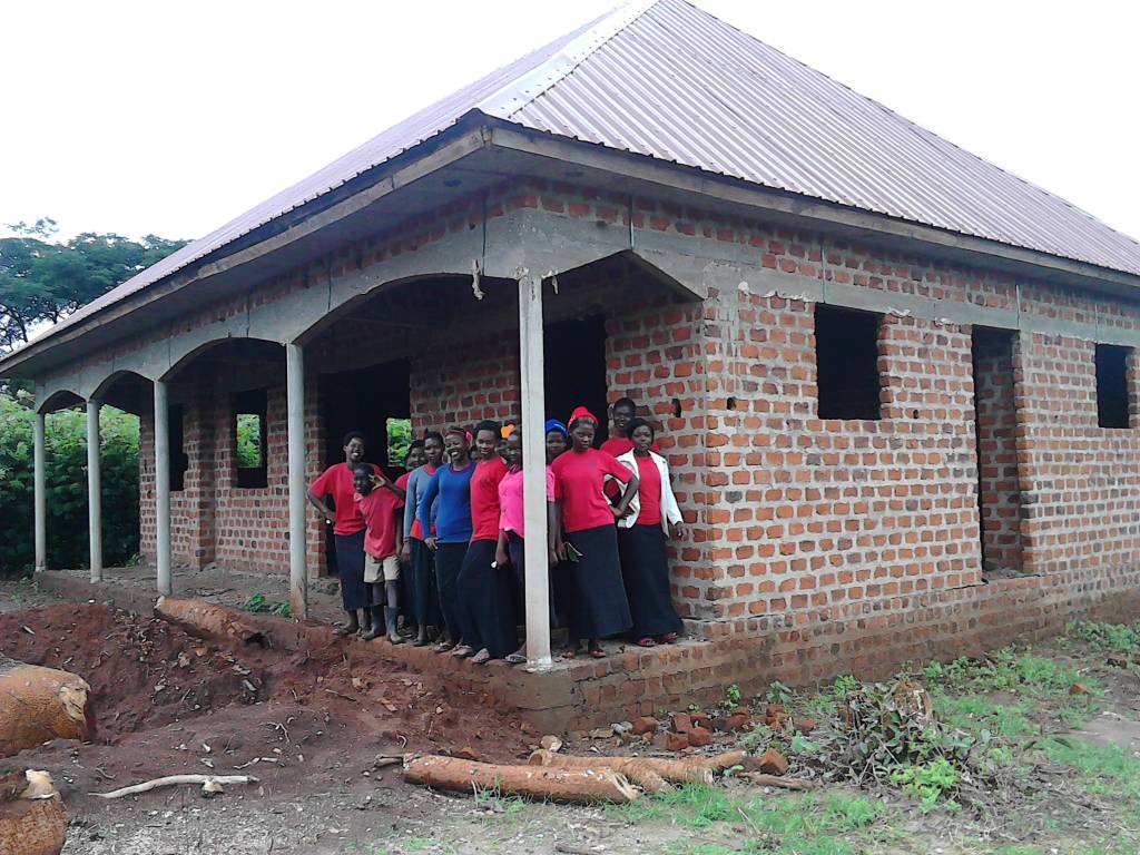 VHC administration building roof complete, May 2018, with girls on the porch.