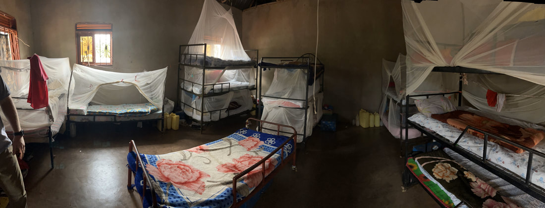 Packed girls' sleeping room: bunk beds and mosquito nets, more than twenty girls in one room.