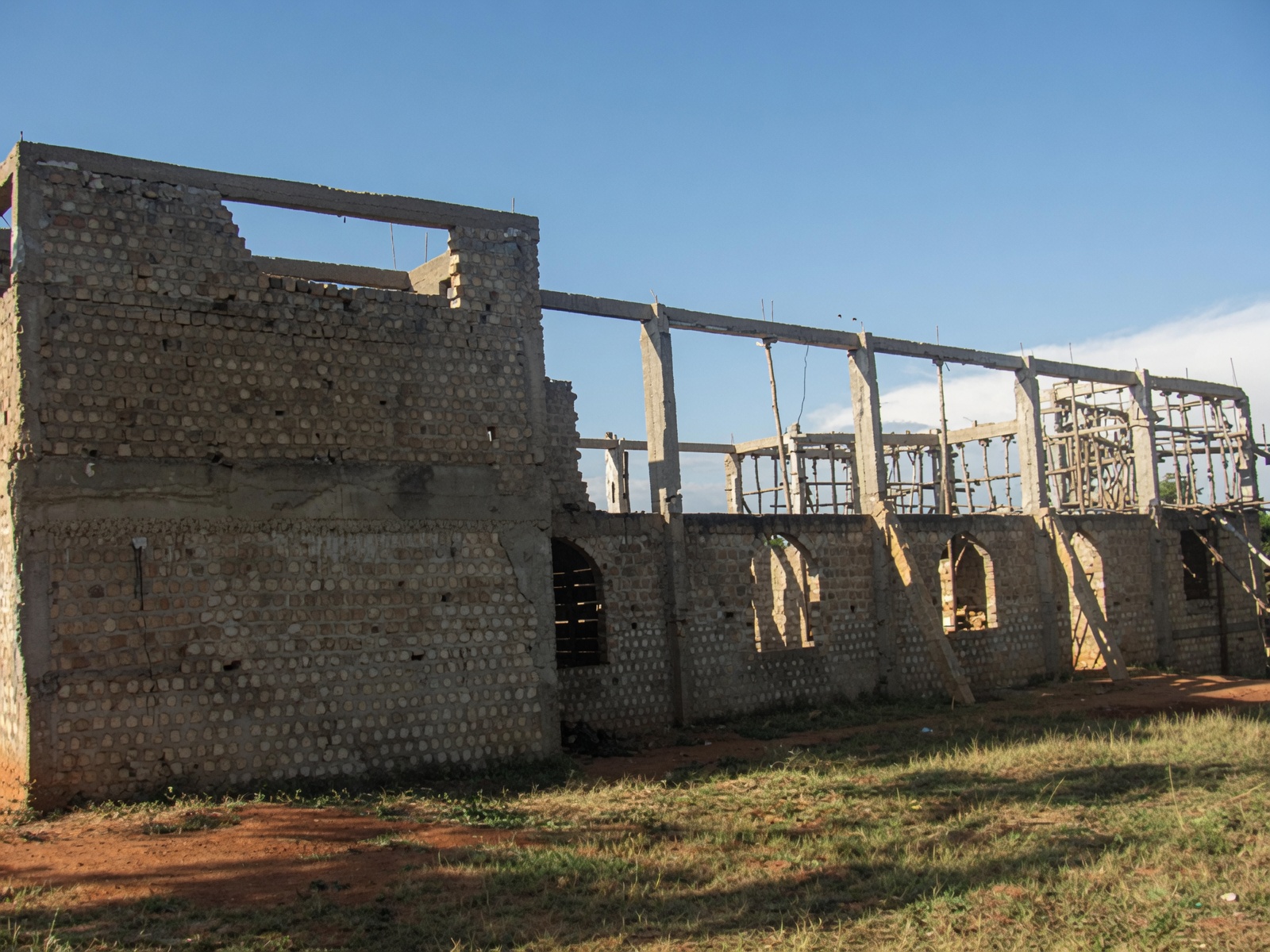 Where it began — brick walls rising on an open field, 2012.