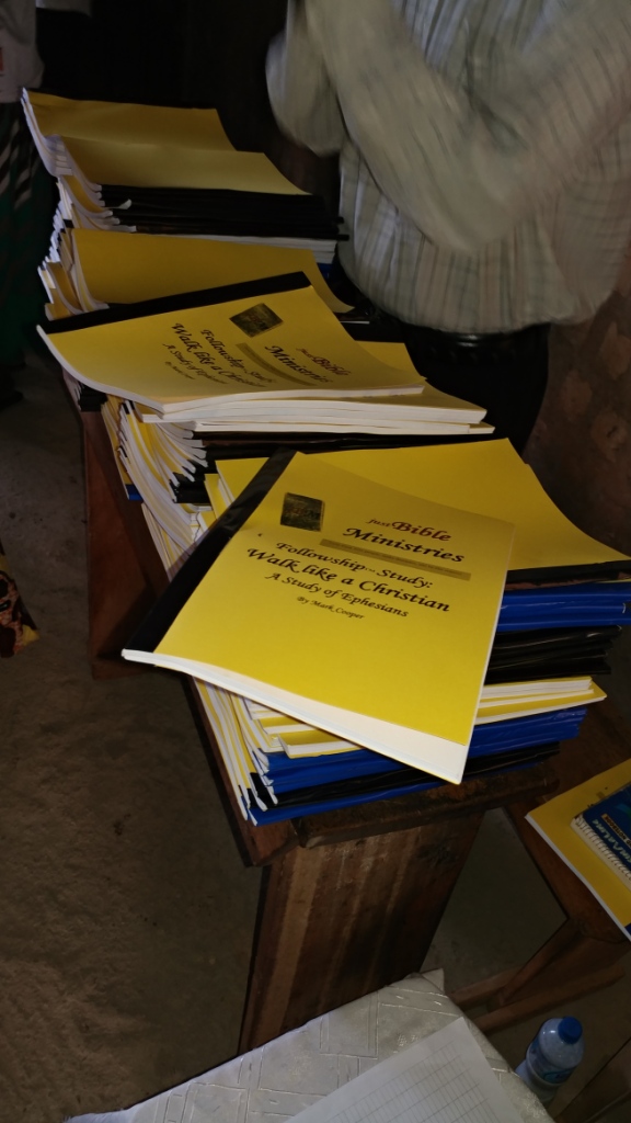 Stacks of yellow justBible Ministries Ephesians workbooks titled Walk like a Christian, July 2017.
